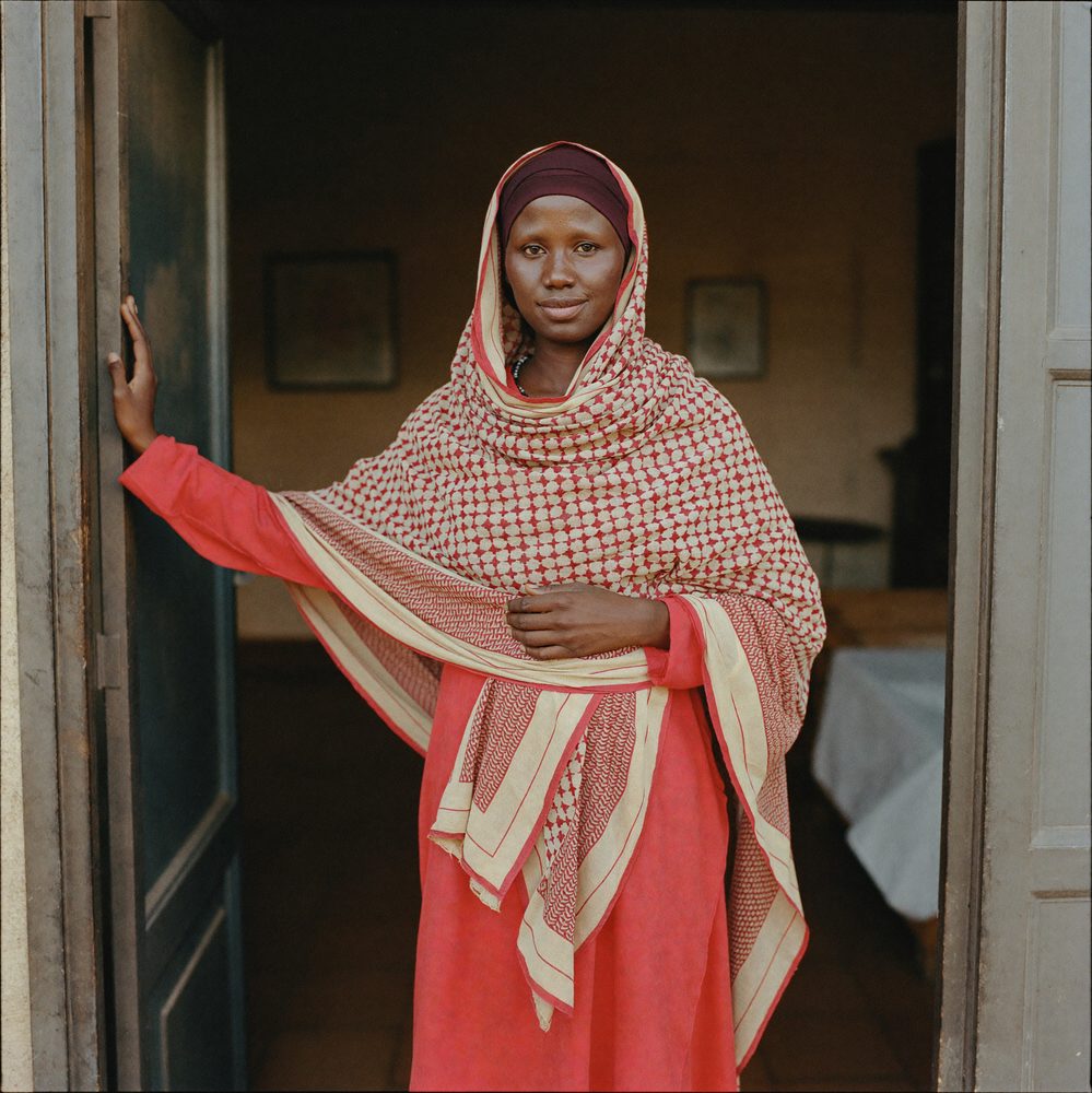 Portrait of a Somali woman entrepreneur standing in the doorway of her business.